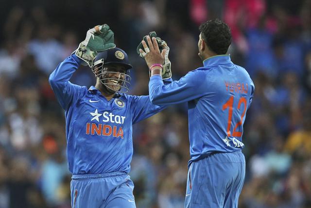 Yuvraj Singh, right, celebrates with MS Dhoni after taking the wicket of Australia's Glenn Maxwell. (AP)
