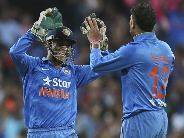 Indian bowler Yuvraj Singh celebrates with MS Dhoni after taking the wicket of Australia's Glenn Maxwell. (AP Photo) 