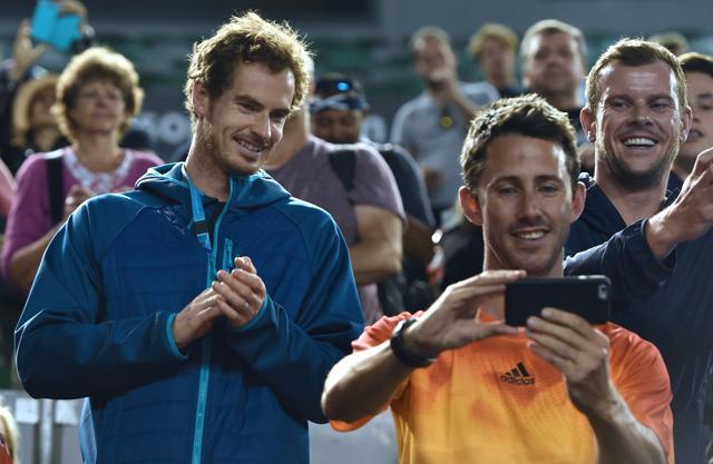 “Andy you should be in bed, I don’t know why you’re here taking photos,” joked Jamie as Andy Murray rushed into the stands to watch Jamie’s trophy presentation. (AFP Photo)