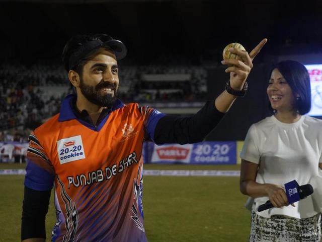 Ayushmann Khurrana gestures towards the crowd during the match. (IANS) 