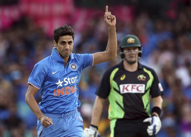 Indian bowler Ashish Nehra points up to the air as he celebrates taking the wicket of Australia's Usman Khawaja during their T20 International cricket match in Sydney. (AP Photo)