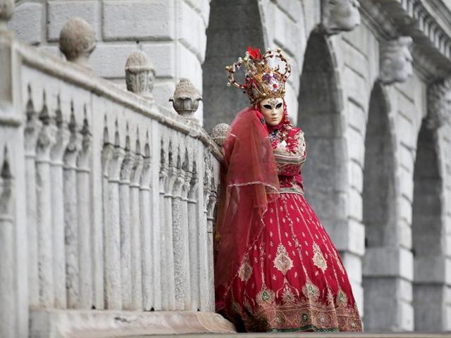 A masked reveller poses during the Venice Carnival in San Marco Piazza.  (REUTERS) 