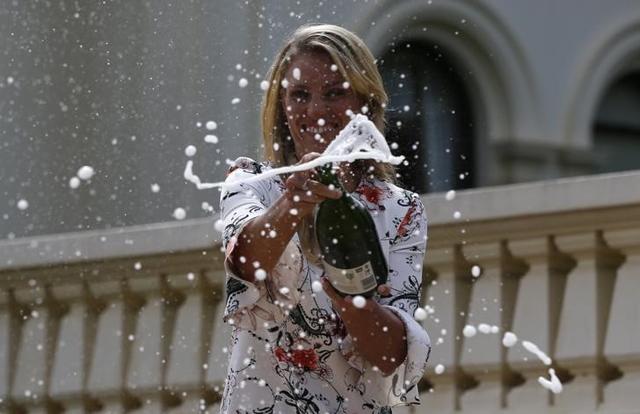 Germany's Angelique Kerber sprays champagne a day after winning her final match at the Australian Open. (Reuters)