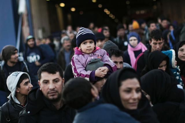 Refugees and migrants disembark from the passenger ferry Blue Star arriving from the island of Lesbos at the port of Piraeus on January 31, 2016 in Athens. (AFP)