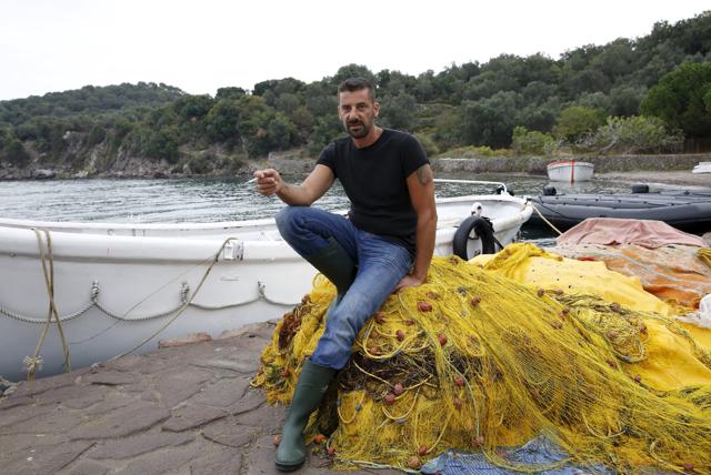 Greek fisherman Stratis Valiamos takes a break at the port of a fishing village in the Greek island of Lesbos. (REUTERS) Greek fisherman Stratis Valiamos takes a break at the port of a fishing village in the Greek island of Lesbos. (REUTERS)