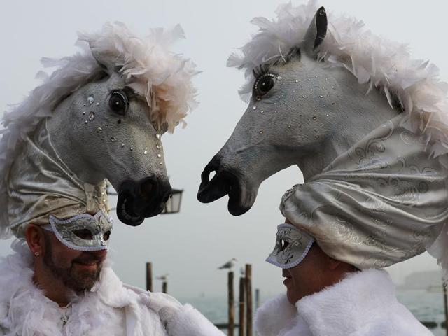 Costumed revellers pose in St Mark’s square (Piazza San Marco) on January 31, 2016 in Venice. The 2016 edition of the Venice carnival is titled Creatum and runs until February 9. (AFP) 