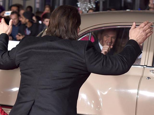 Channing Tatum points to Josh Brolin from the inside of a car as Tatum arrives at the world premiere. (Jordan Strauss/Invision/AP) 