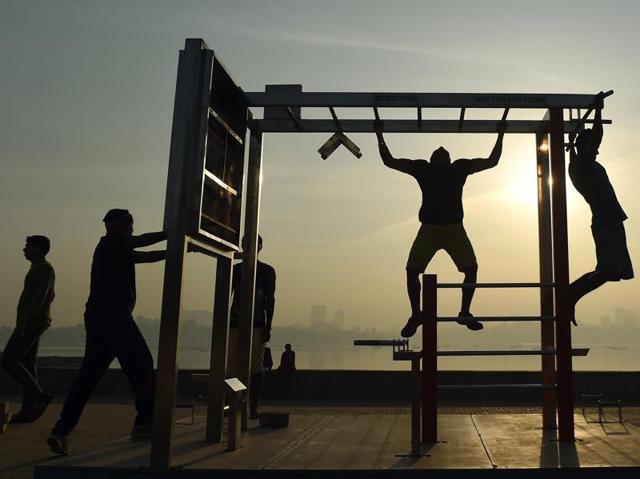 Youth exercising near the sea front during a hazy morning in Mumbai. (AFP)
