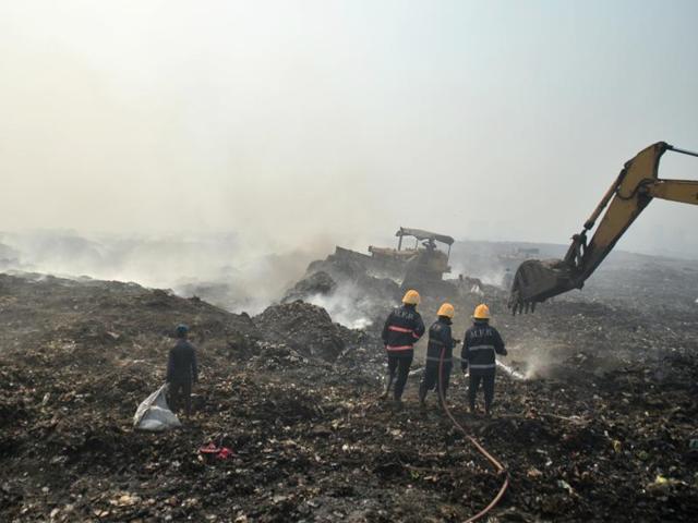 Fire personal trying to extinguish the fire which is been there for past 2 days at Deonar Dumping Ground in Shivaji Nagar. (Prashant Wayanade/HT)