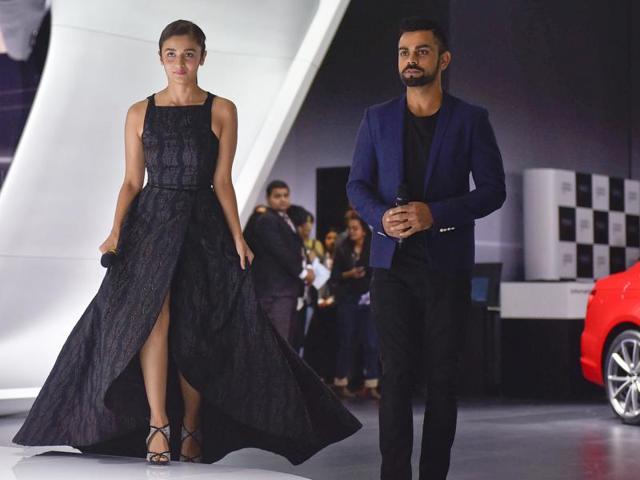 Virat Kohali and Alia Bhatt pose next to Audi R8v10 Plus during its launch at Auto Expo 2016. (Ravi Choudhary/HT)