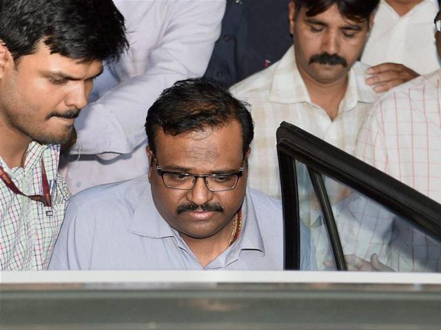 Sameer Bhujbal, nephew of NCP leader Chhagan Bhujbal, being taken to the Sessions Court in Mumbai on Tuesday. (PTI) Sameer Bhujbal, nephew of NCP leader Chhagan Bhujbal, being taken to the Sessions Court in Mumbai on Tuesday. (PTI)