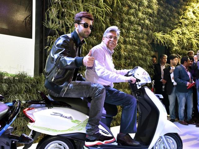 Ranbir Kapoor rides pillion with Pawan Munjal, chairman of Hero Motors at the launch of electric scooter concept Duet-E. (Mohd Zakir/HT)