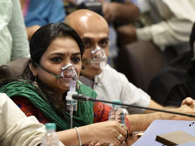 Congress corporators wear oxygen masks during the BMC’s budget session to protest against the pollution caused by the Deonar dumping ground fire, on Wednesday.(Arijit Sen/HT)