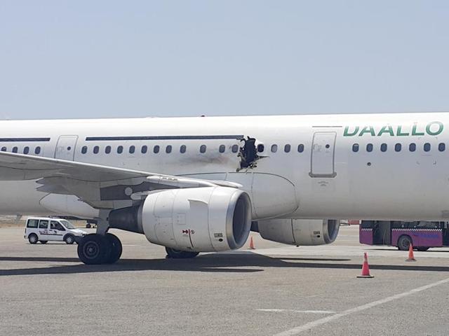 A hole is photographed in a plane operated by Daallo Airlines as it sits on the runway of the airport in Mogadishu, Somalia. (AP Photo) A hole is photographed in a plane operated by Daallo Airlines as it sits on the runway of the airport in Mogadishu, Somalia. (AP Photo)