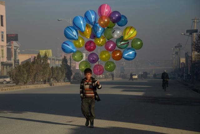 Afghan boy Hizbullah, 10, walks as he looks for customers to buy his balloons on the streets of Mazar-i-Sharif on February 3. (AFP) Afghan boy Hizbullah, 10, walks as he looks for customers to buy his balloons on the streets of Mazar-i-Sharif on February 3. (AFP)