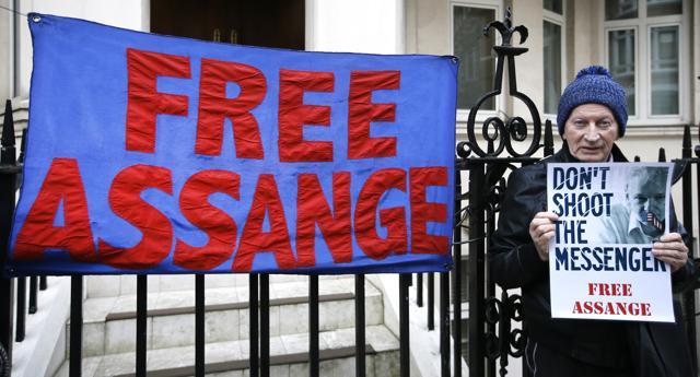 A demonstrator holds a banner outside the Ecuadorean Embassy in London, where Wikileaks founder Julian Assange is staying. (AP Photo) A demonstrator holds a banner outside the Ecuadorean Embassy in London, where Wikileaks founder Julian Assange is staying. (AP Photo)