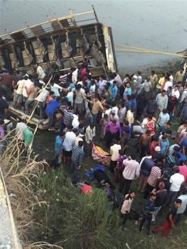 People carry out rescue work after a state transport bus fell off a bridge into the Purna river. (PTI) People carry out rescue work after a state transport bus fell off a bridge into the Purna river. (PTI)