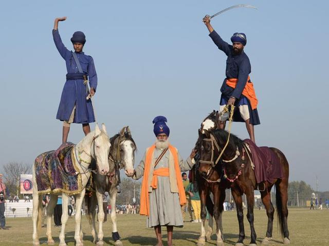 BALANCING ACT: Nihangs showing off their skills at the 80th Kila Raipur Rural Games Festival near Ludhiana on Friday. (Sikander Singh Chopra/HT Photo)