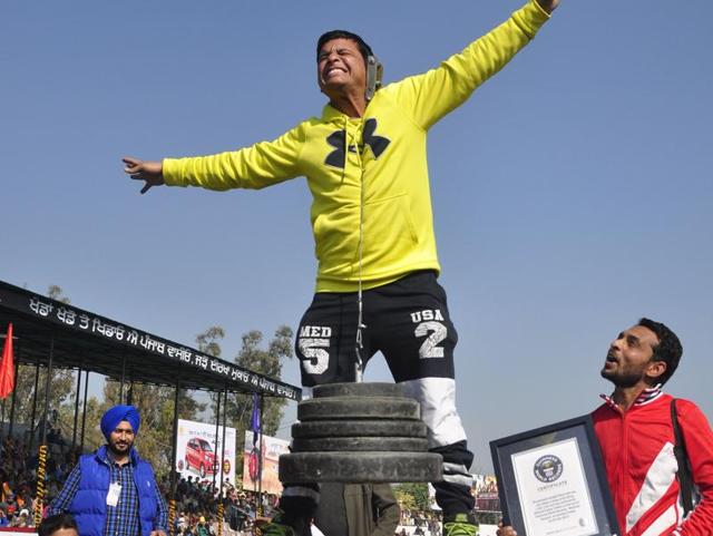 EAR POWER: A man named Rakesh Kumar lifting 82 kg of weight with his ear during the 80th Kila Raipur Rural Games Festival near Ludhiana on Friday. (Sikander Singh Chopra/HT Photo)