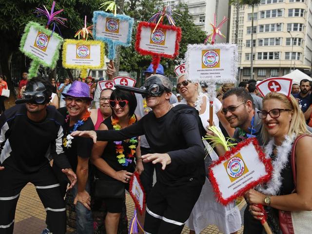 Public health workers, two wearing Aedes aegypti mosquito costumes pose for a photo during a street carnival block party as part of a campaign to warn people about the spread of the Zika virus, in Sao Paulo, Brazil. (AP) 