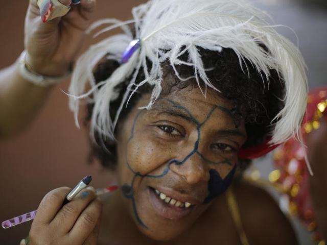 A patient from the Nise de Silveira mental health institute gets her face painted for the institute's carnival parade, called in Portuguese: "Loucura Suburbana," or Suburban Madness, in the streets of Rio de Janeiro, Brazil. (AP) 
