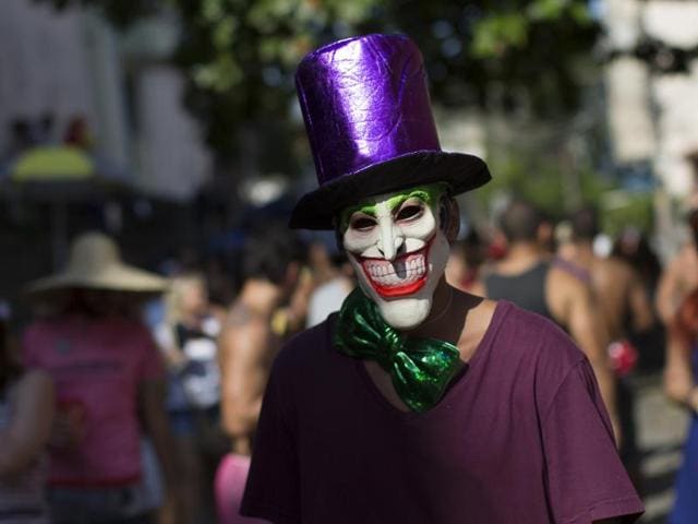 A reveller wearing a mask depicting the ‘The Joker’ comic character, attends the ‘Carmelitas’ block party during Carnival celebrations in Rio de Janeiro, Brazil. (AP) 
