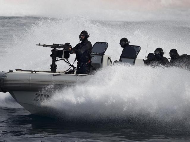 Indian naval commandos show their prowess during the International Fleet Review in Vishakapatnam. (AP Photo)