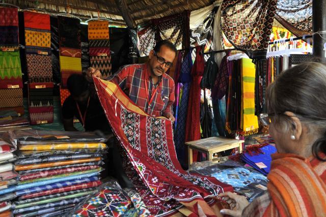 Sampath Kumar Sirimilla, master weaver from Hyderabad displays saris from his Gopika collection that features Rajasthani and Warli motifs on hand-woven silk. Available at: Stall 175; Price: Rs 8,000 onwards (Abhinav Saha/ HT Photos) Sampath Kumar Sirimilla, master weaver from Hyderabad displays saris from his Gopika collection that features Rajasthani and Warli motifs on hand-woven silk. Available at: Stall 175; Price: Rs 8,000 onwards (Abhinav Saha/ HT Photos)