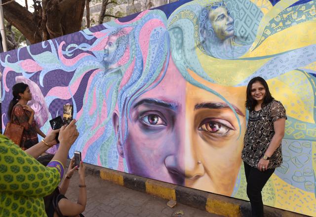 Revellers at take pictures with street art displayed at the fest. (Anshuman Poyrekar/ Hindustan Times)