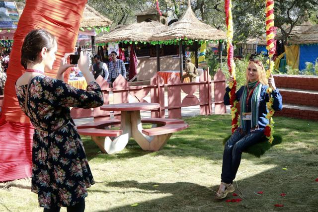 A foreign visitor enjoys the swing during the Basant celebrations at the fair. (Photo Courtesy: Haryana Tourism) A foreign visitor enjoys the swing during the Basant celebrations at the fair. (Photo Courtesy: Haryana Tourism)