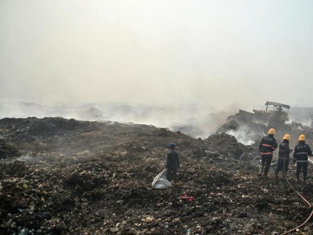 Fire safety officials extinguishing a fire at Deonar Dumping Ground in Shivaji Nagar in Mumbai. India’s cities are struggling to cope with managing their waste output, largely due to that vast difference between official procedures and de facto management systems.(HT Photo)