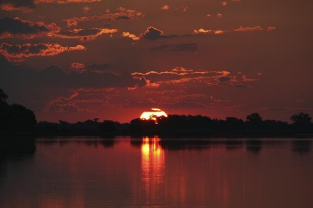 Visitors can enjoy a romantic sunset on the banks of the Thamalakane River. (Istock) Visitors can enjoy a romantic sunset on the banks of the Thamalakane River. (Istock)