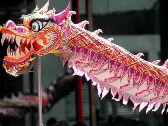 Dragon dancers make their way through a crowd to perform on Monday at Chinatown district in Manila, Philippines. (AP) 