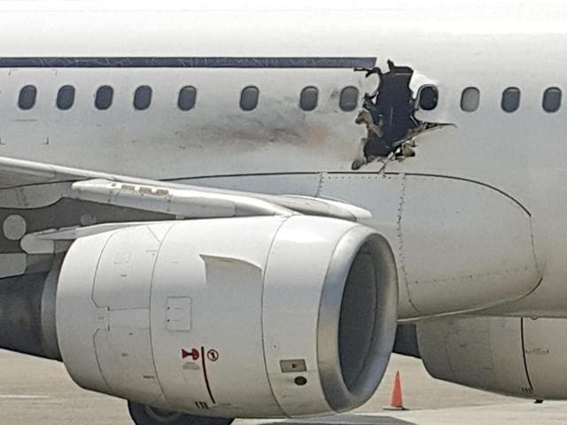In this file photo, a hole is photographed in a plane operated by Daallo Airlines as it sits on the runway of the airport in Mogadishu, Somalia. After initially saying there was no sign of foul play, Somali officials said Saturday, Feb. 6, 2016 that a suicide bomber is suspected to have set off the explosive inside the plane. (AP) In this file photo, a hole is photographed in a plane operated by Daallo Airlines as it sits on the runway of the airport in Mogadishu, Somalia. After initially saying there was no sign of foul play, Somali officials said Saturday, Feb. 6, 2016 that a suicide bomber is suspected to have set off the explosive inside the plane. (AP)