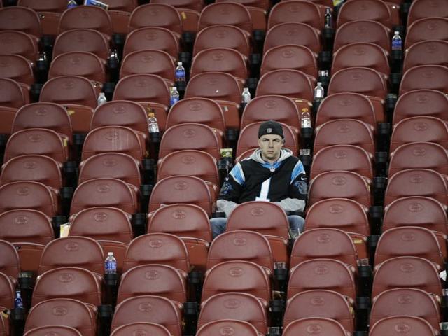 A Carolina Panthers fan sits in the stands after the NFL Super Bowl 50 football game. (AP Photo) 