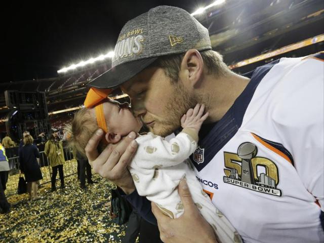 Denver Broncos’ Britton Colquitt kisses his daughter Isla after the NFL Super Bowl 50. (AP Photo) 