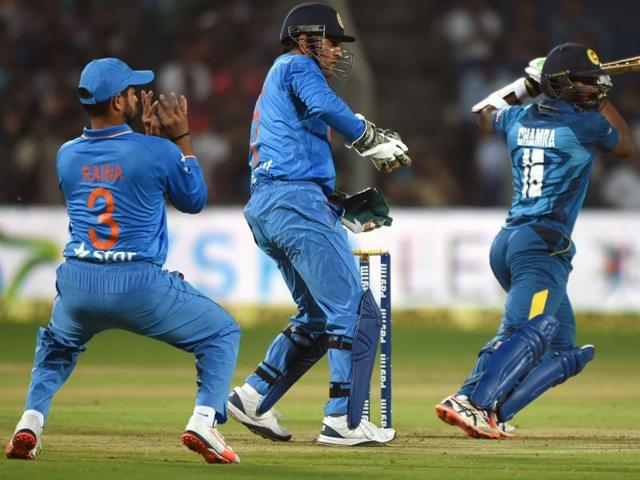 India's Mahendra Singh Dhoni (C) and Suresh Raina react as Chamara Kapugedera plays a shot. (AFP Photo) India's Mahendra Singh Dhoni (C) and Suresh Raina react as Chamara Kapugedera plays a shot. (AFP Photo)