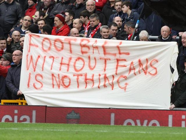 Liverpool fans hold up signs that says ‘football without fans is nothing’ in protest against the ticket prices . (Reuters) Liverpool fans hold up signs that says ‘football without fans is nothing’ in protest against the ticket prices . (Reuters)