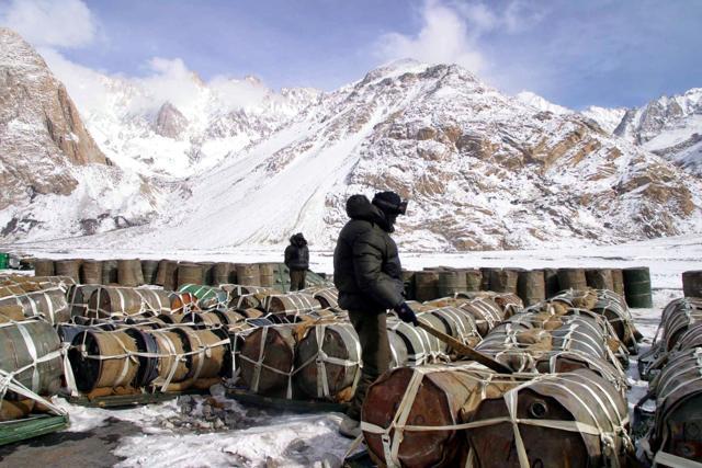 An Indian army soldier stands guard near drums of oil at an army camp in Siachen Glacier. (AP) An Indian army soldier stands guard near drums of oil at an army camp in Siachen Glacier. (AP)