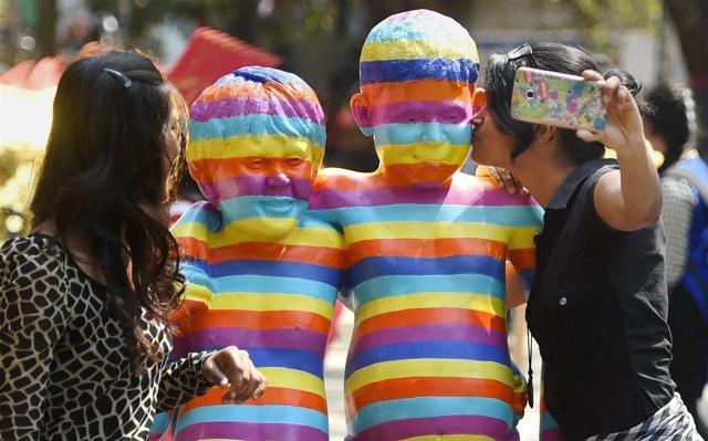 Girls click selfies with an art installation at the Kala Ghoda arts festival in Mumbai. (PTI) Girls click selfies with an art installation at the Kala Ghoda arts festival in Mumbai. (PTI)