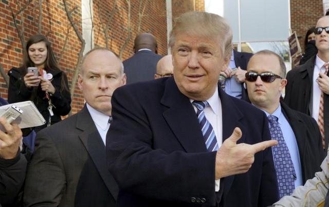 US Republican presidential candidate Donald Trump points at a supporter at a polling place for the presidential primary in Manchester, New Hampshire. (Reuters) US Republican presidential candidate Donald Trump points at a supporter at a polling place for the presidential primary in Manchester, New Hampshire. (Reuters)