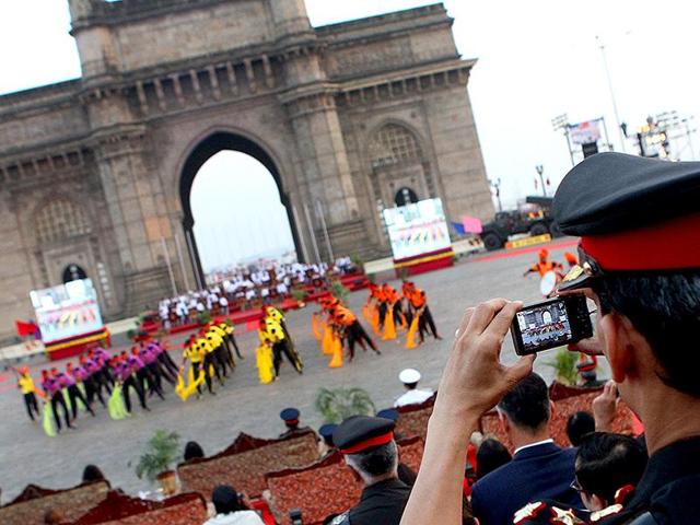 An Army officer takes photographs of a cultural program on Army Day celebration at Gateway of India in Mumbai. The city’s name was changed in 1995.(HT photo)