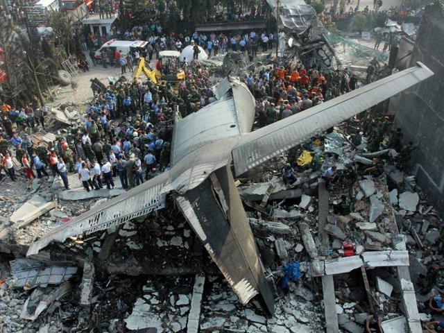Rescuers search for victims where an air force cargo plane crashed in Medan, North Sumatra, Indonesia, in June last year. Another military plane crashed into a house near an air base in Malang, east Java, on Wednesday. Three people, including the pilot, were killed.(AP File Photo)