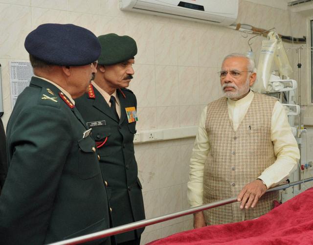 Prime minister Narendra Modi with Army chief Gen Dalbir Singh and head of the medical team in the ward at a ward of Army’s Research and Referral Hospital where Lance Naik Koppad is being treated. The PM had tweeted that he was going to see the Lance Naik with “the prayers of the entire nation”. (PTI Photo) Prime minister Narendra Modi with Army chief Gen Dalbir Singh and head of the medical team in the ward at a ward of Army’s Research and Referral Hospital where Lance Naik Koppad is being treated. The PM had tweeted that he was going to see the Lance Naik with “the prayers of the entire nation”. (PTI Photo)
