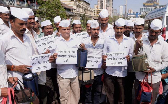 Mumbai Dabbawalas pray for army man Hanumanthappa Koppad in Mumbai on Wednesday. (PTI Photo)