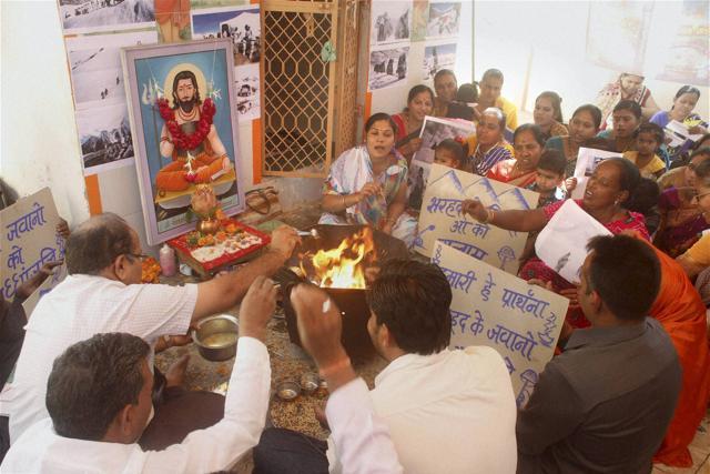 People pray for speedy recovery of Lance Naik Hanumanthappa Koppad, who was seriously injured and rescued after six days in Siachen avalanche incident, at a temple in Ahmedabad on Wednesday. (PTI Photo)