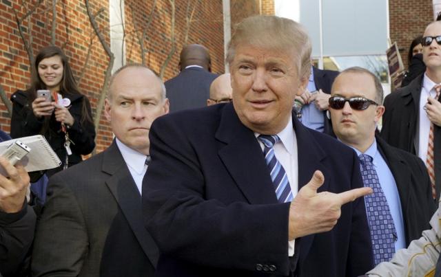 US Republican presidential candidate Donald Trump points at a supporter at a polling place for the presidential primary in Manchester, New Hampshire. (REUTERS) US Republican presidential candidate Donald Trump points at a supporter at a polling place for the presidential primary in Manchester, New Hampshire. (REUTERS)