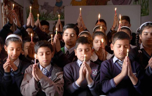 School children take part in a candle light vigil for the Indian soldiers who died in an avalanche at the Siachen Glacier, in Jammu on Wednesday. (PTI Photo)