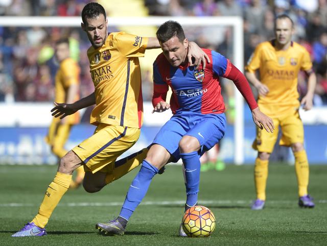 Barcelona's midfielder Sergio Busquets (L) vies with Levante's defender Tono Garcia during the Spanish league football match Levante UD vs FC Barcelona. (AFP) Barcelona's midfielder Sergio Busquets (L) vies with Levante's defender Tono Garcia during the Spanish league football match Levante UD vs FC Barcelona. (AFP)