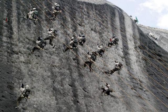 Indian army soldiers climb an ice wall at the Siachen Base camp. (AP)